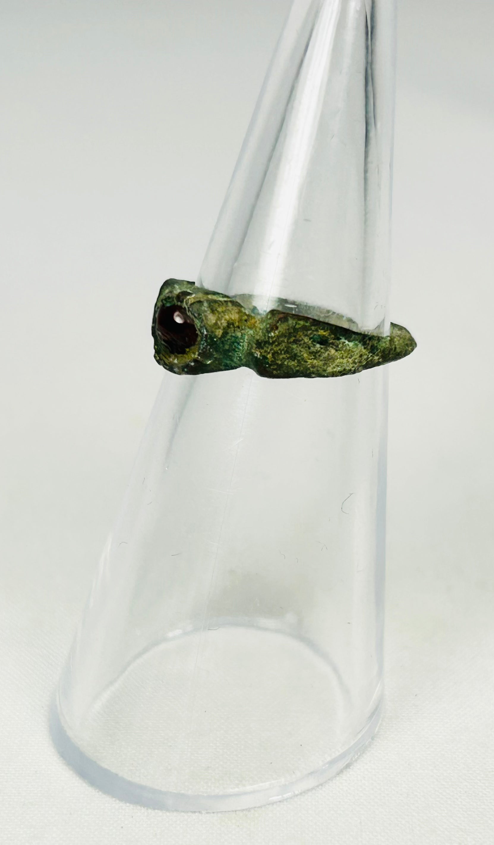 Roman Imperial bronze ring with rich olive-green patina and inset wine-red garnet