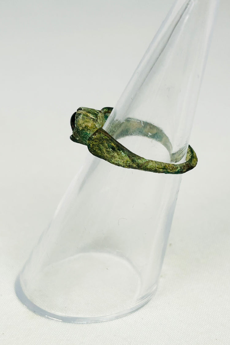 Archaeological Roman jewelry artifact displayed on museum-style black presentation stand