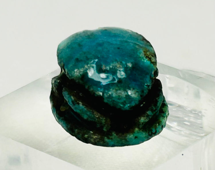 Small New Kingdom scarab bead amulet with strong blue coloration and historic aging