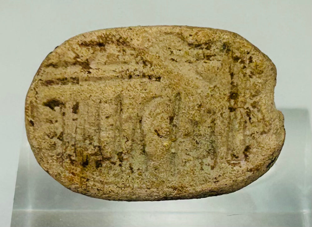 Underside of Egyptian scarab amulet showing carved symbolic linear markings