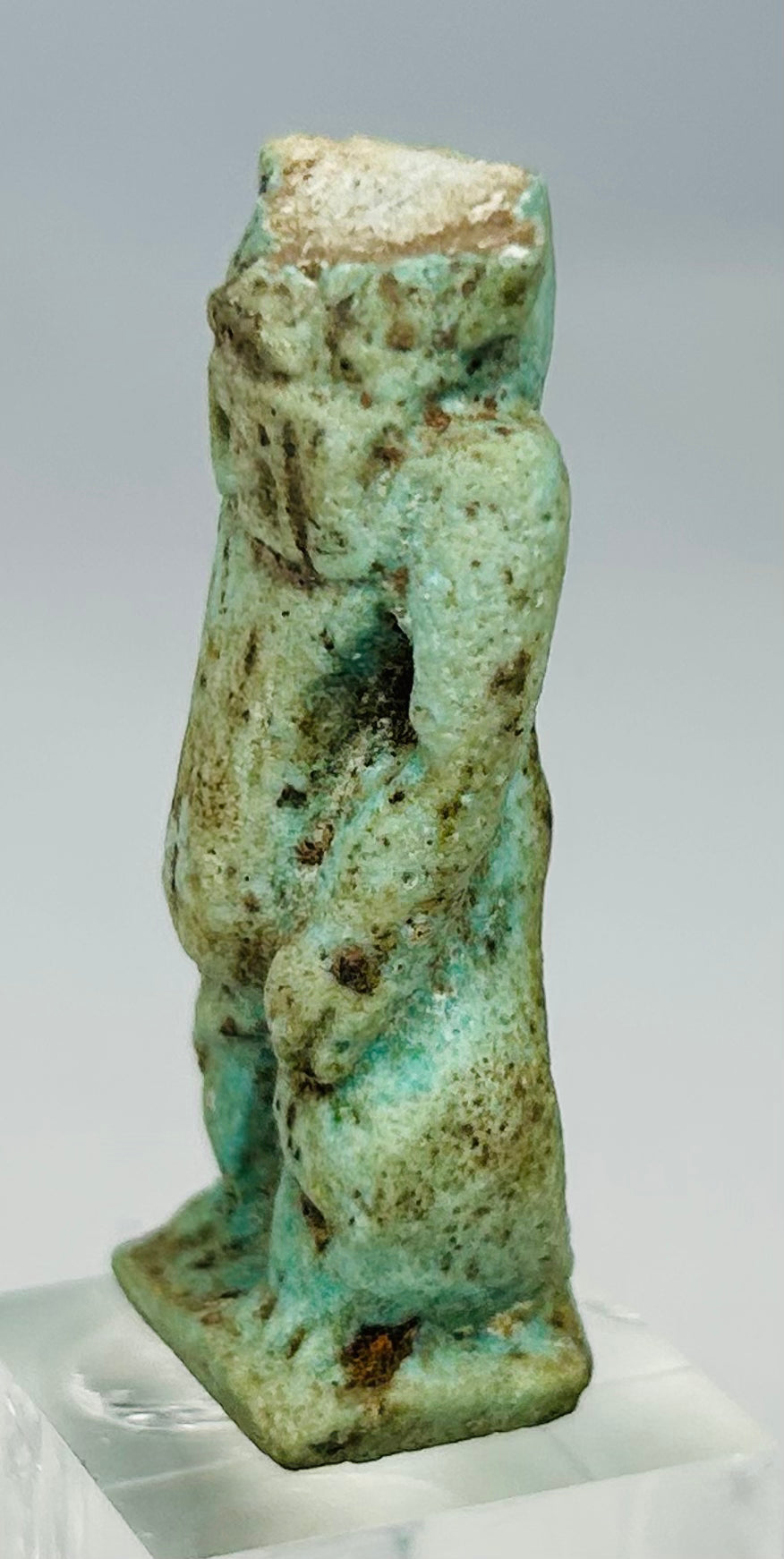 Ancient Egyptian protective deity amulet with turquoise-blue glazed surface and burial patina