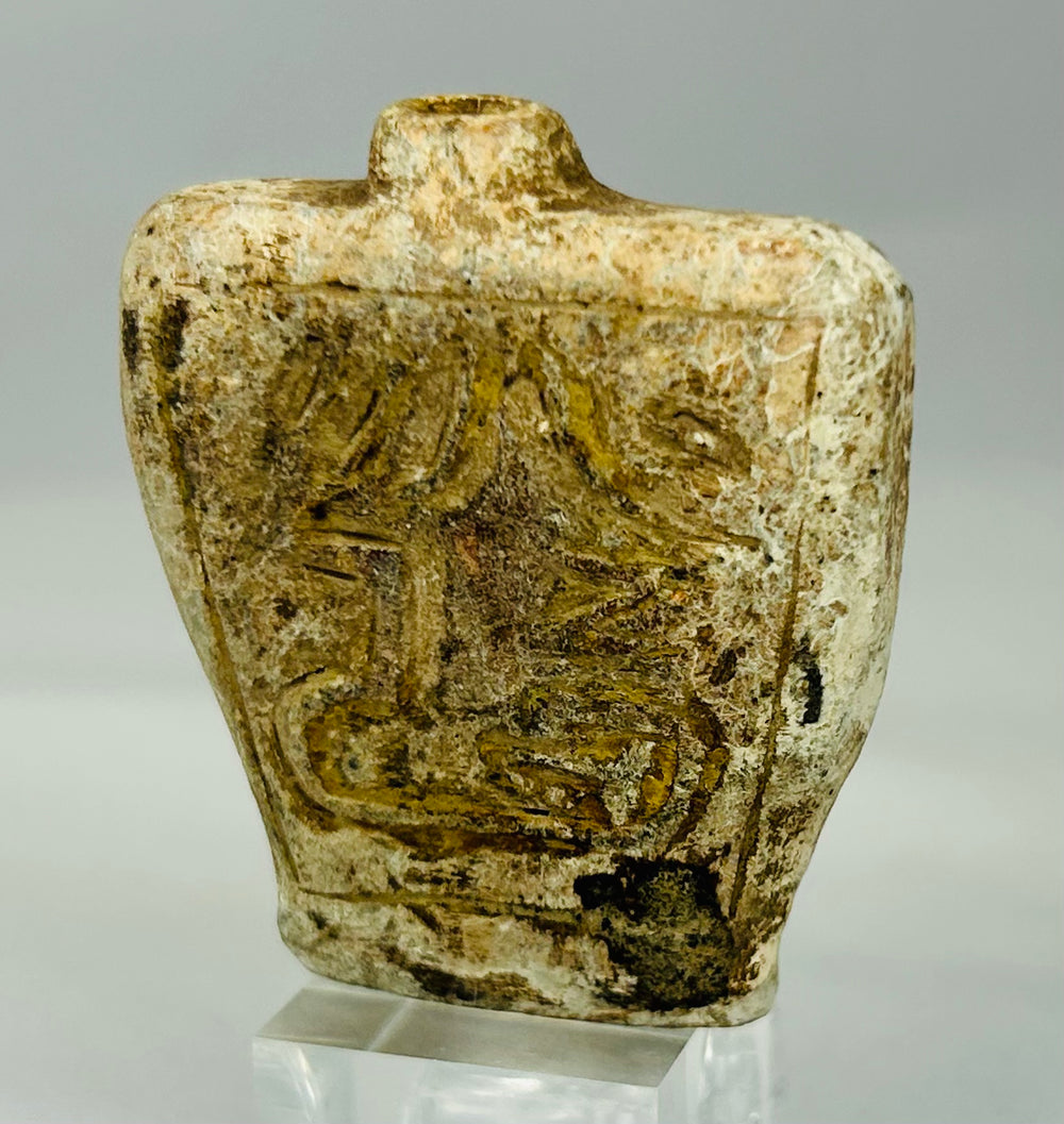 Small carved limestone or calcite flask with mineral deposits and ancient wear