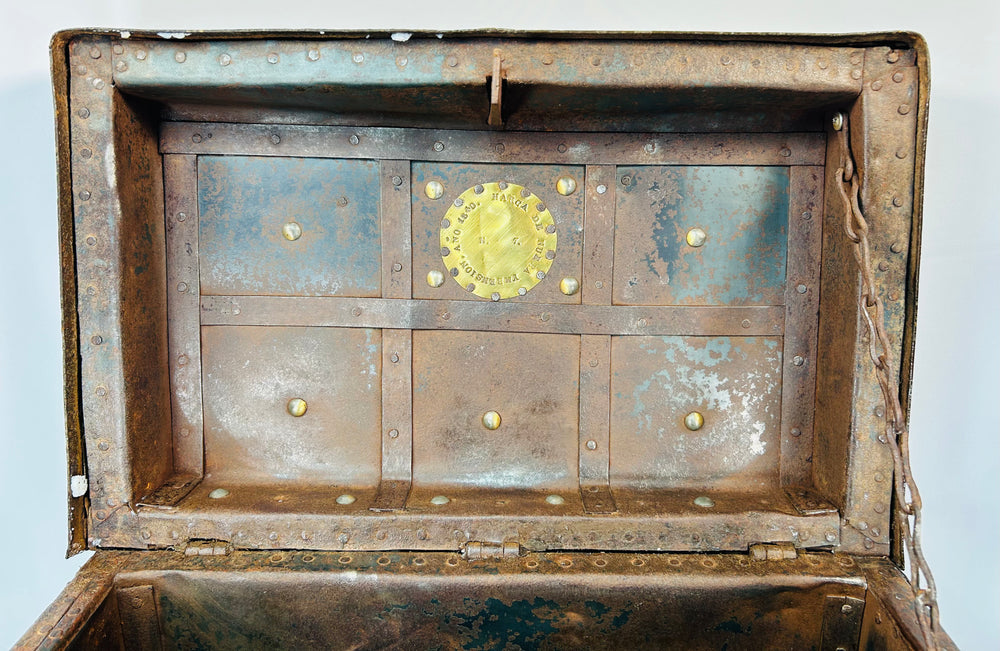 European wrought-iron strongbox with decorative studded panels, missing handle on one side, and authentic aged patina