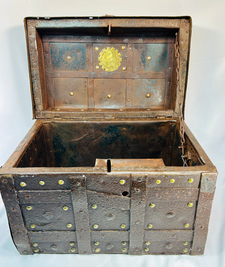 Heavy wrought-iron strongbox with brass plaque reading “Año 1840,” decorative studs, and signs of extensive working life use