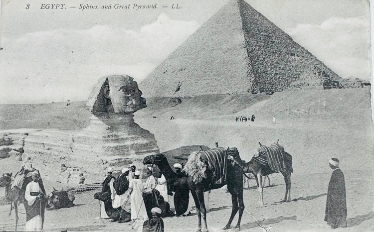 Early 20th-century Egyptian postcard showing the Great Sphinx and Great Pyramid of Giza with travellers and camels