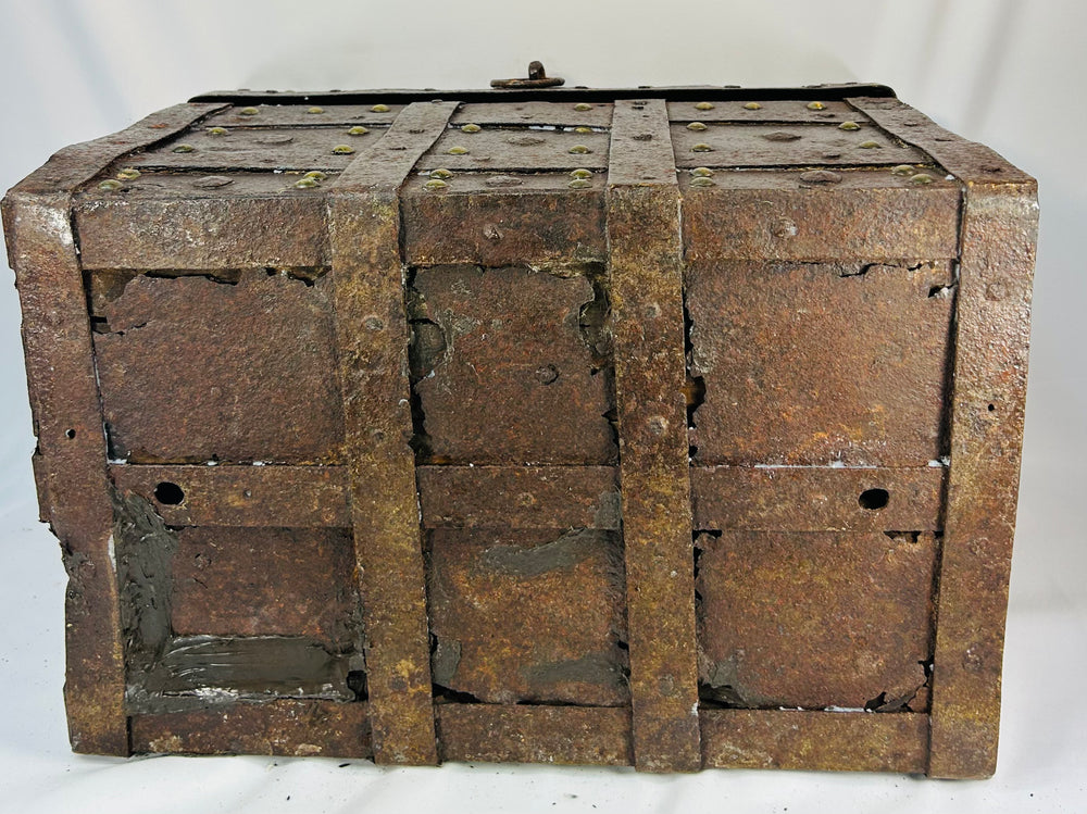 Authentic antique iron security chest with one surviving forged handle, interior chain, and thick riveted construction