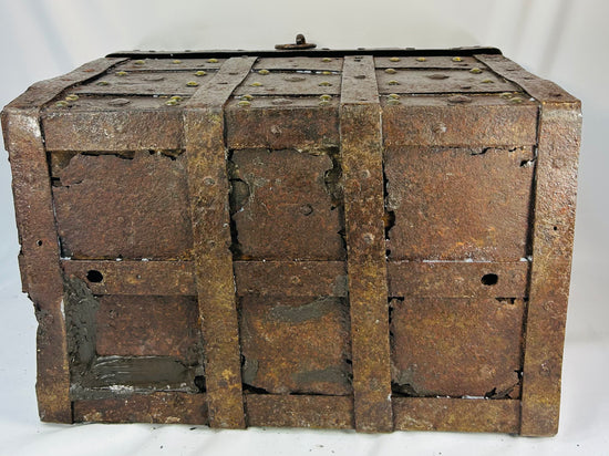 Authentic antique iron security chest with one surviving forged handle, interior chain, and thick riveted construction