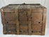 Authentic antique iron security chest with one surviving forged handle, interior chain, and thick riveted construction