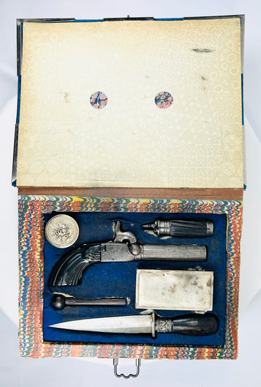 Mid-19th century Liège percussion pistol and dagger defense kit hidden inside velvet-bound faux book