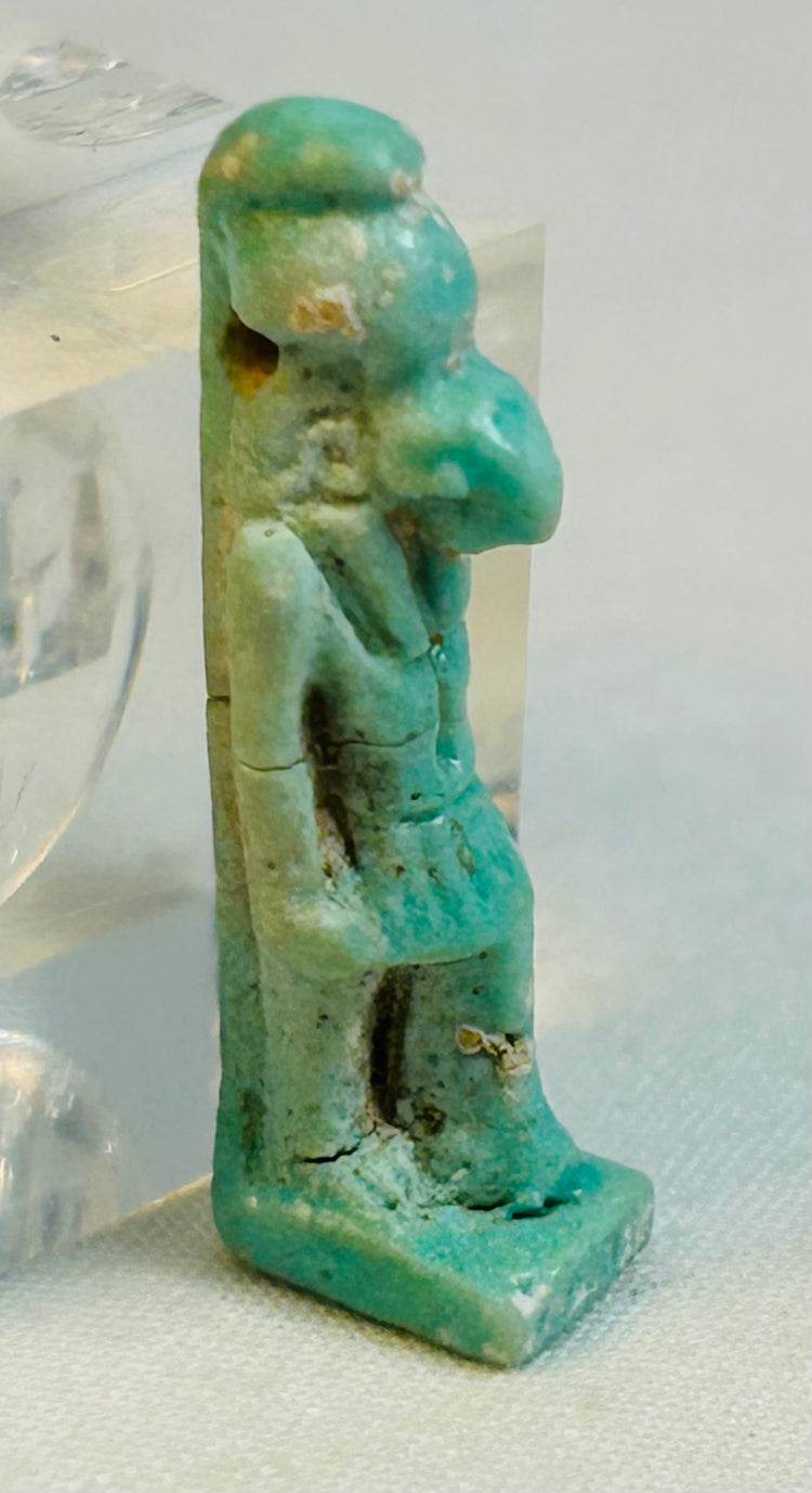 Standing falcon-headed Egyptian amulet with defined posture and pierced suspension hole