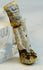 Macro photograph highlighting mineral deposits and aged surface of Egyptian amulet.
