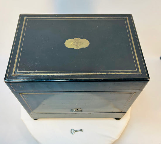 Antique ebonized medical cabinet with brass inlay and crowned crest plaque on the lid