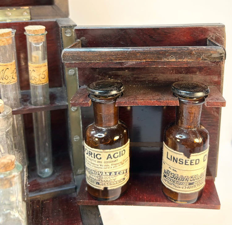 Close-up of Victorian apothecary bottles with paper labels and aged patina