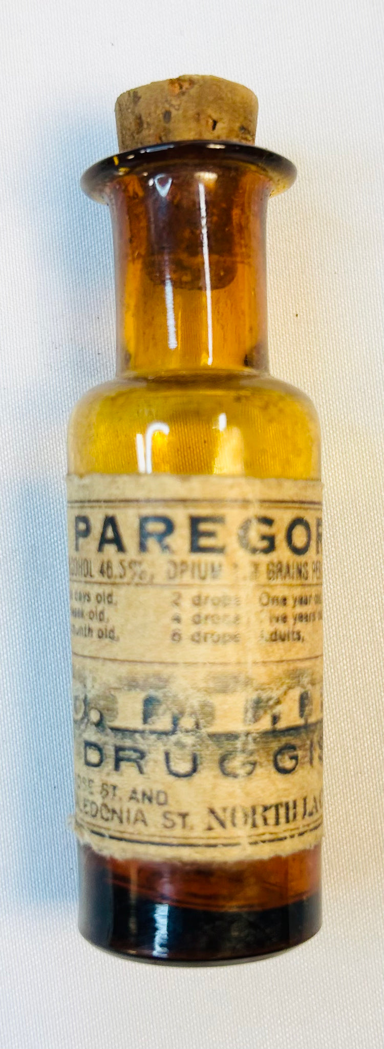 Close-up of Victorian apothecary bottles with paper labels and aged patina