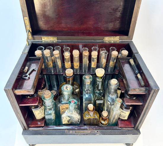 Detailed view of brass key and locking mechanism on antique medical cabinet