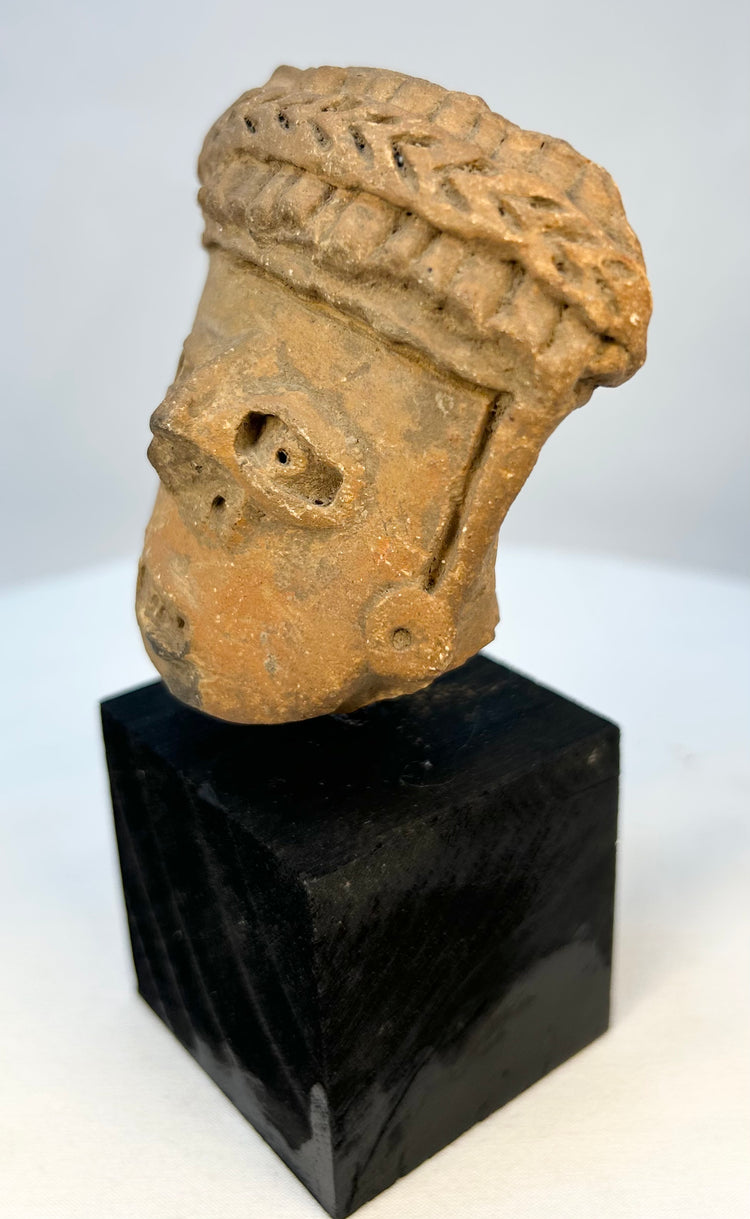 Antique terracotta figurine head from ancient West Mexico archaeology