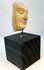 Archaic Classical terracotta face relic mounted for display
