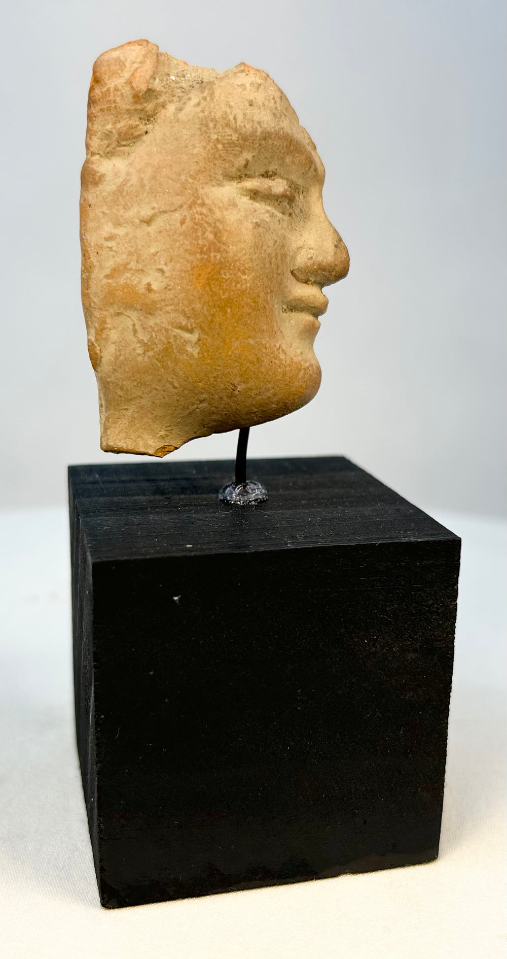 Authentic ancient terracotta facial fragment with archaeological wear