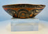 Ancient Mesoamerican ceramic bowl showing bold black, white, and orange painted motifs
