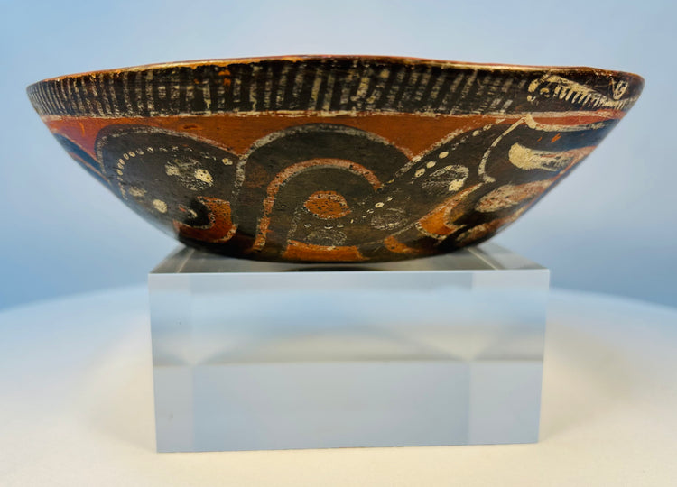 Ancient Mesoamerican ceramic bowl showing bold black, white, and orange painted motifs