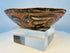 Antique hand-painted Pre-Columbian pottery bowl displayed on clear museum stand