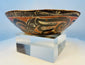 Antique hand-painted Pre-Columbian pottery bowl displayed on clear museum stand