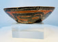 Ancient ceramic bowl with black-and-white painted decoration over orange clay body