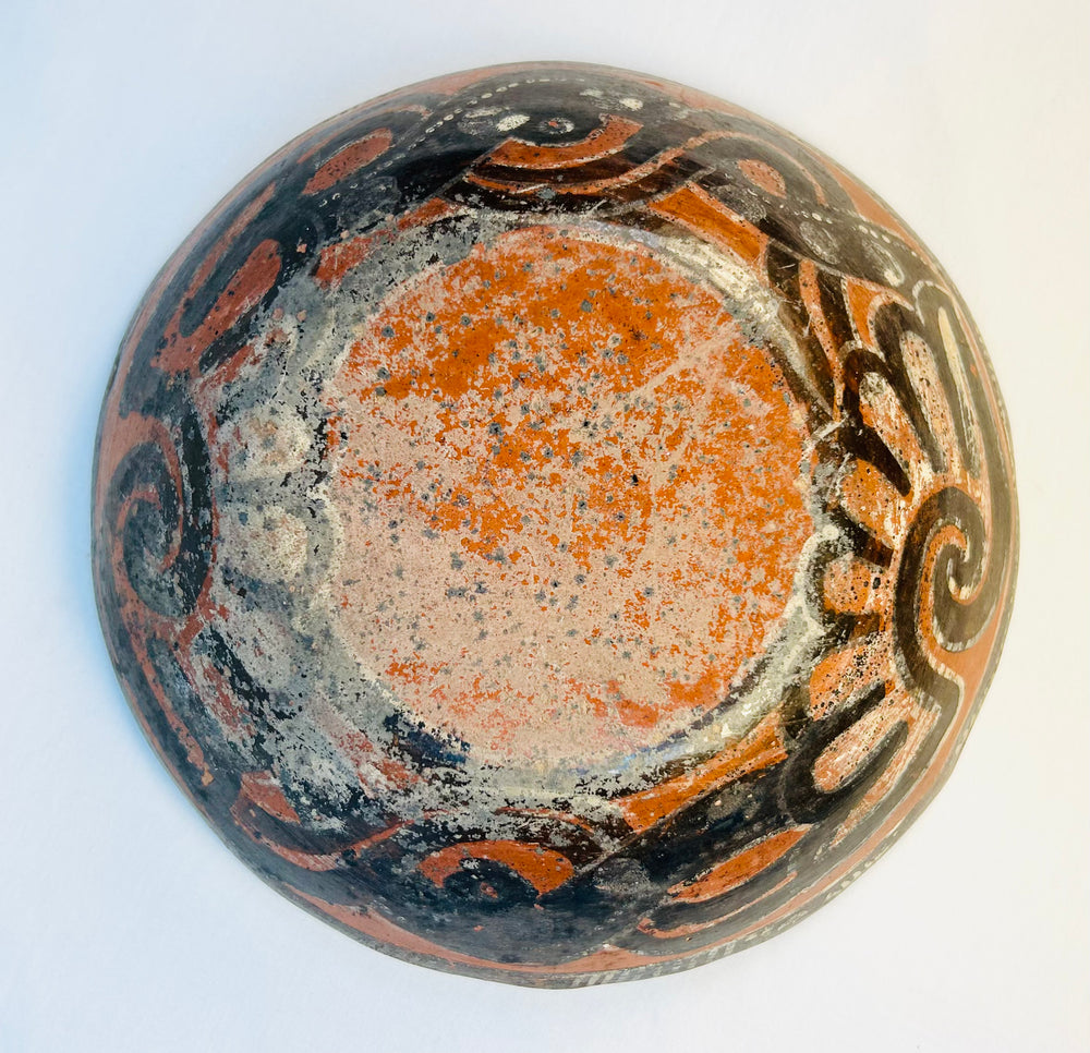 Underside of ancient Mesoamerican bowl showing original paint and age patination