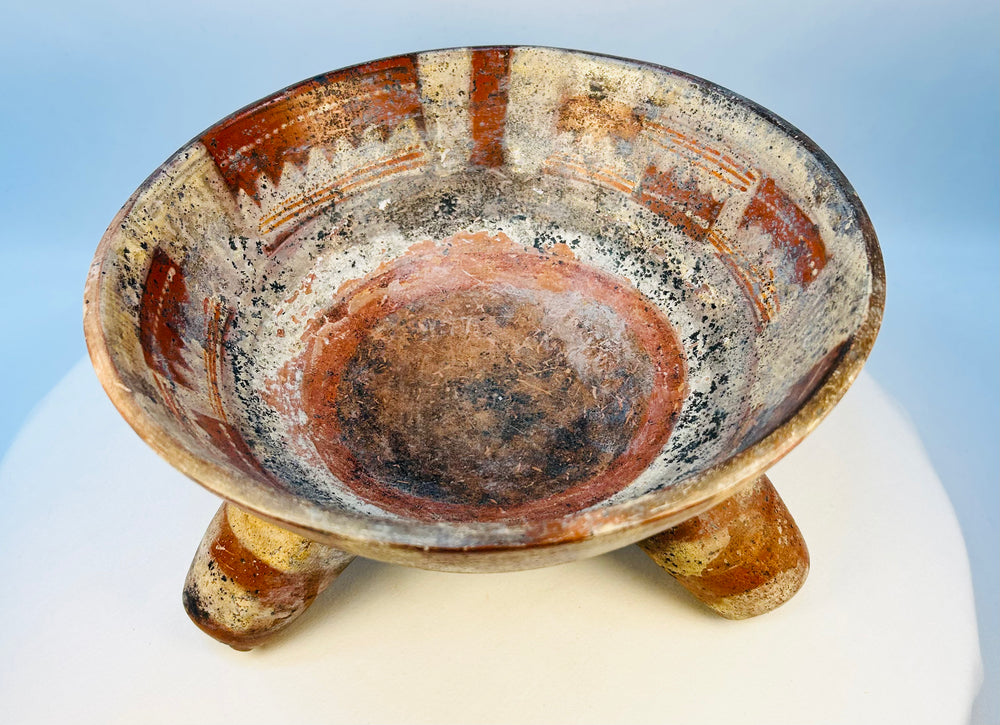Interior view of ancient tripod bowl showing painted decoration and patina
