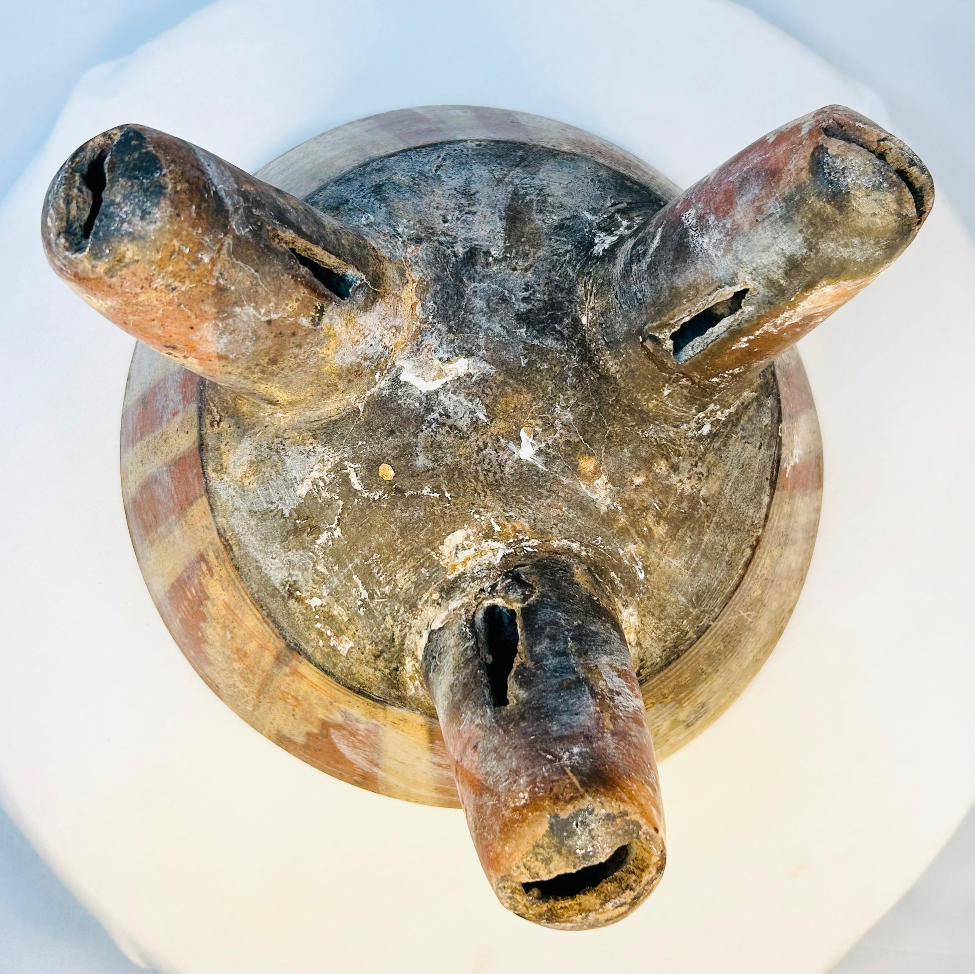 Underside view of ancient West Mexican tripod bowl showing hollow legs