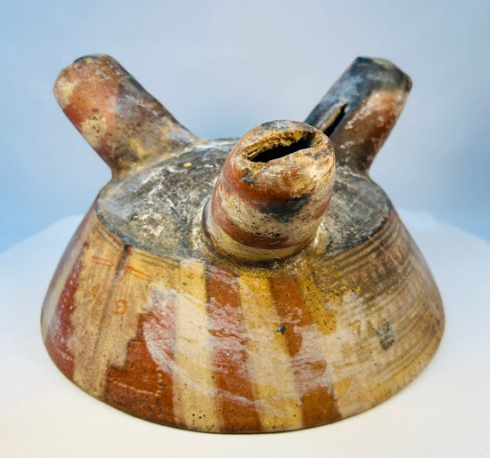 Ancient ceramic tripod vessel from West Mexico with bold geometric striping