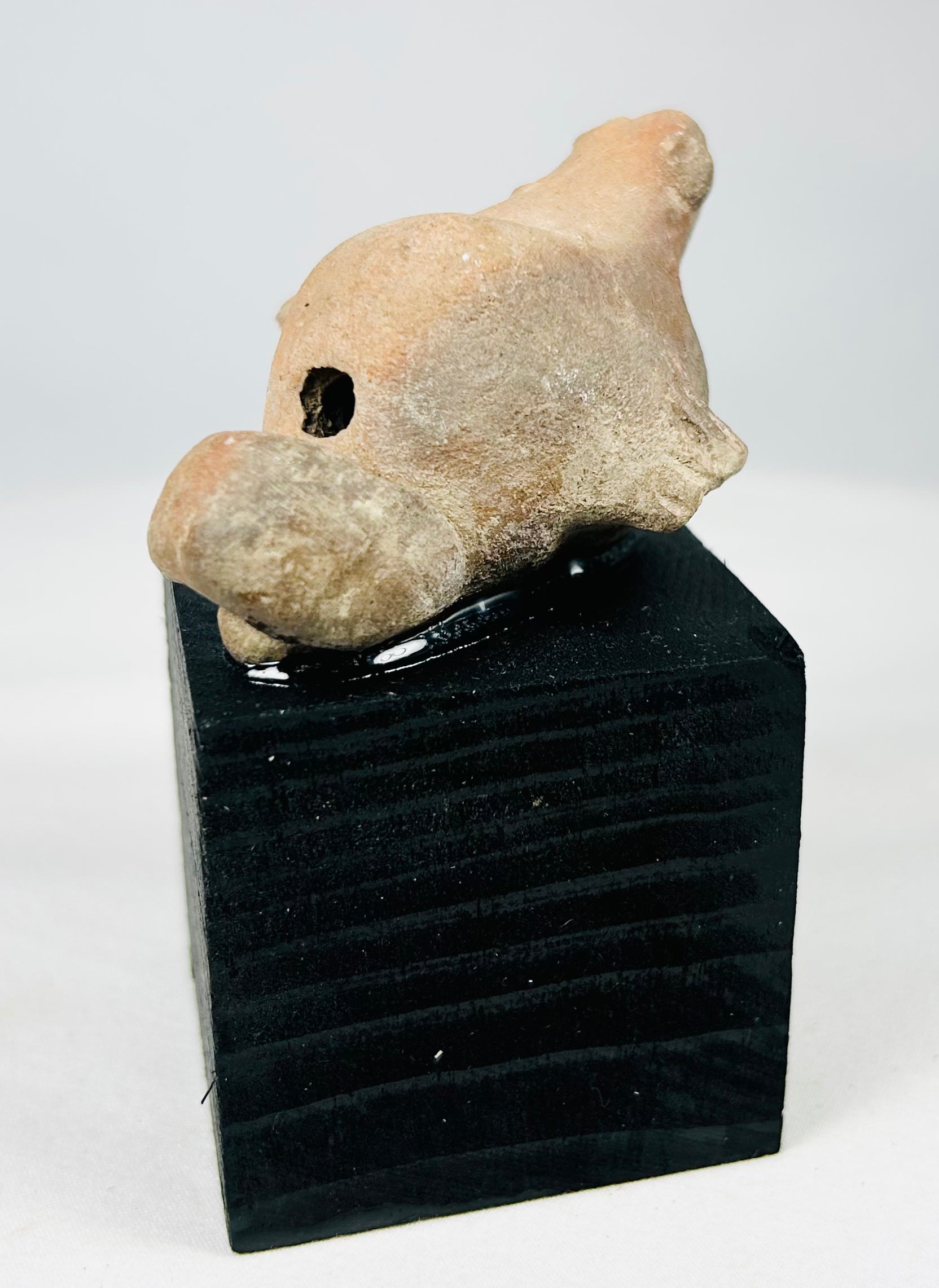 Hand-modeled ancient Mesoamerican terracotta animal figurine from the shaft tomb culture period, showing encrustations and age wear