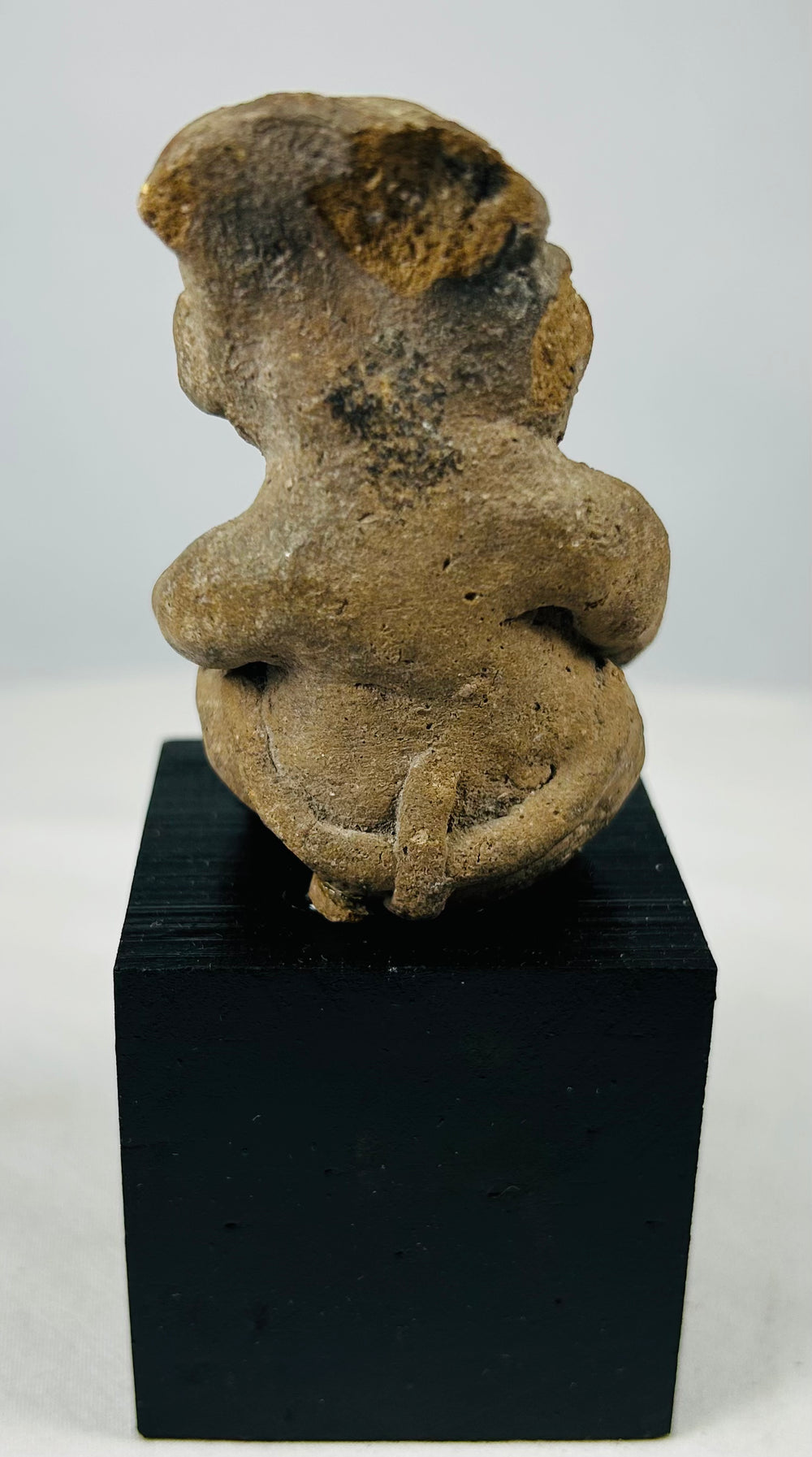 Ancient Mesoamerican terracotta male effigy with projecting arms and legs, burial deposits, and archaeological surface wear