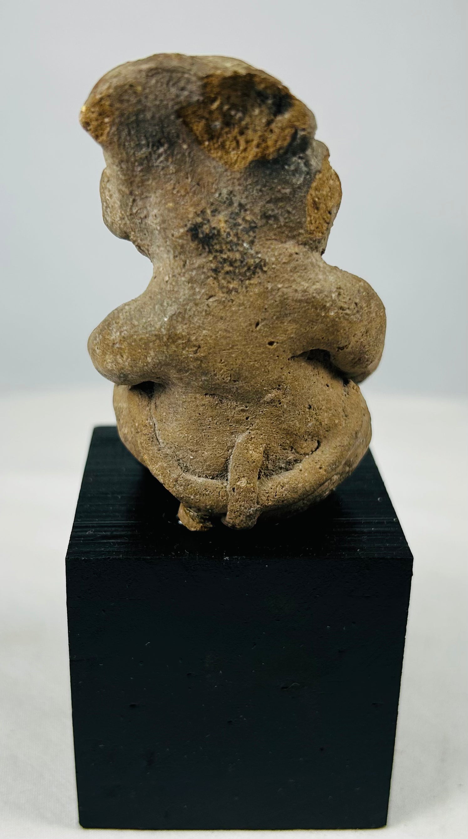 Ancient Mesoamerican terracotta male effigy with projecting arms and legs, burial deposits, and archaeological surface wear