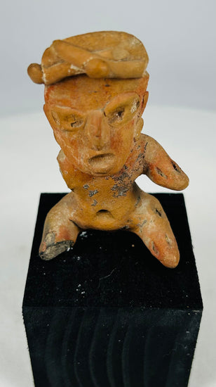 Ancient Mesoamerican terracotta seated figure with defined brows, open mouth expression, and ritual presence