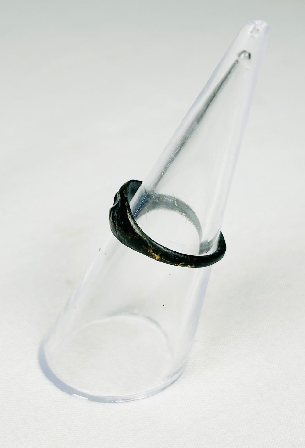 Roman bronze ring with symbolic rodent motif, worn band, and earthen deposits