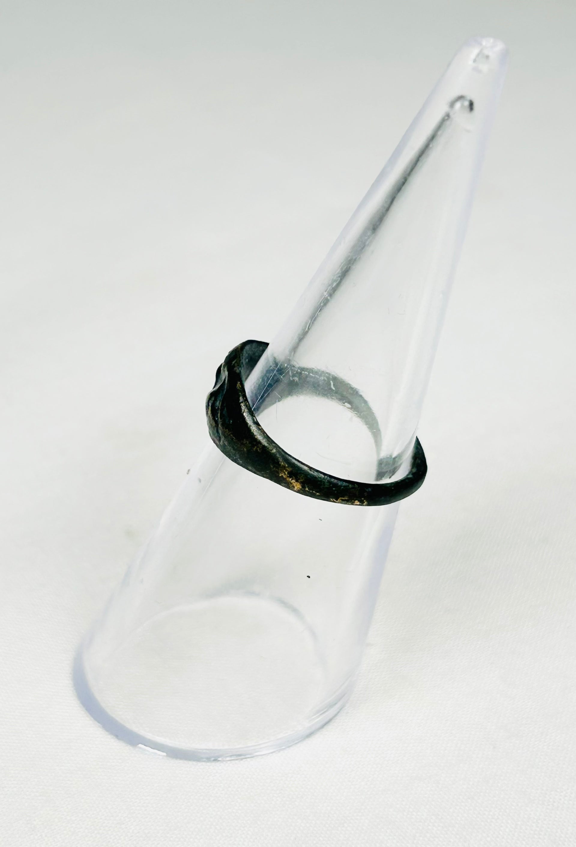 Roman bronze ring with symbolic rodent motif, worn band, and earthen deposits