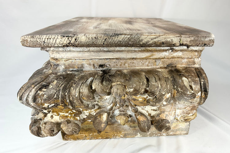 Decorative antique wooden architectural element featuring rich carving and aged surface texture