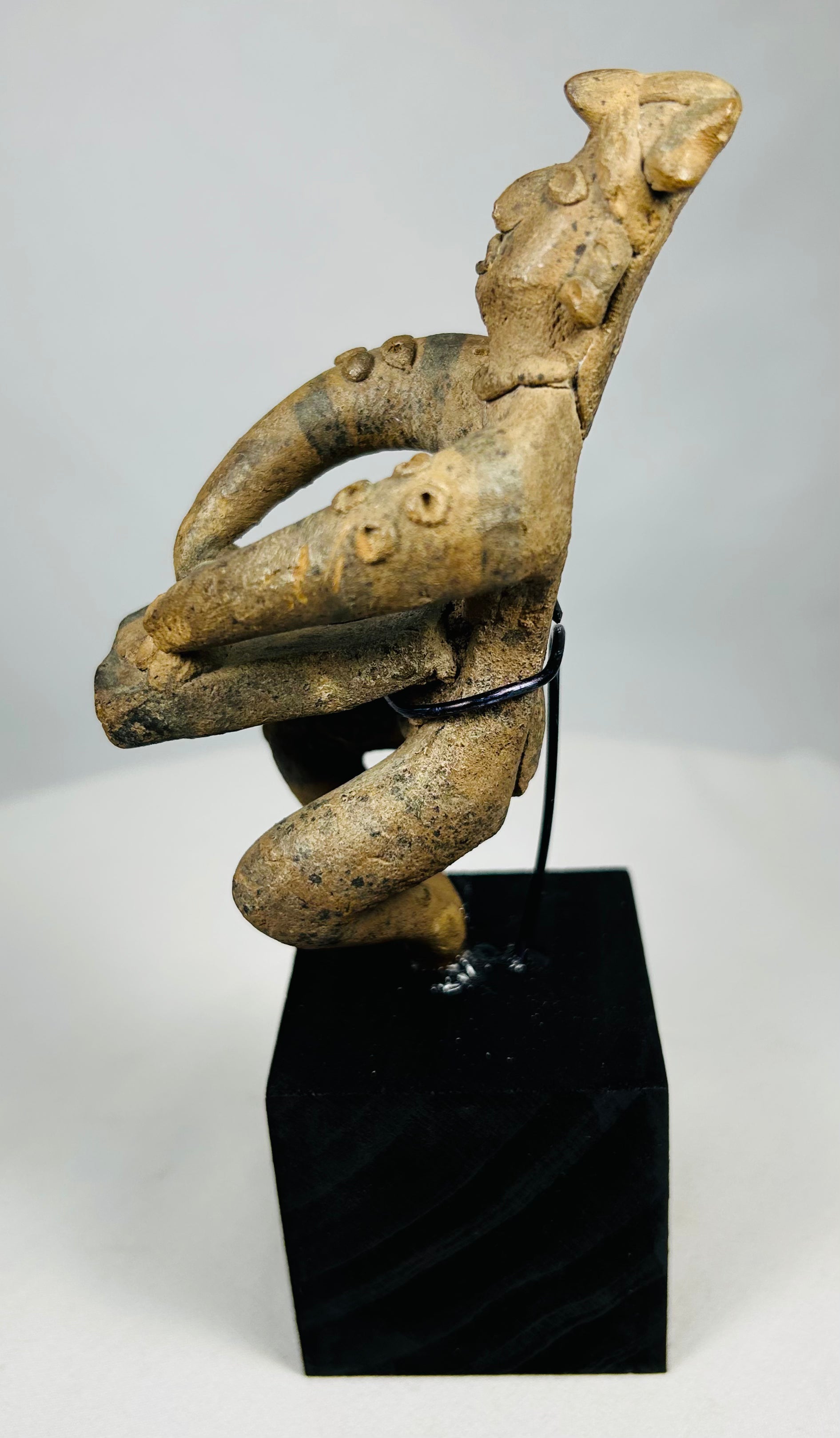 Ancient West Mexican terracotta musician showing stylized facial features