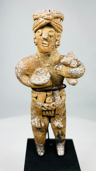 Close-up of ancient West Mexican terracotta figure with stylized facial features