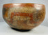 Ancient Mesoamerican hemispherical terracotta bowl with earth-tone pigments