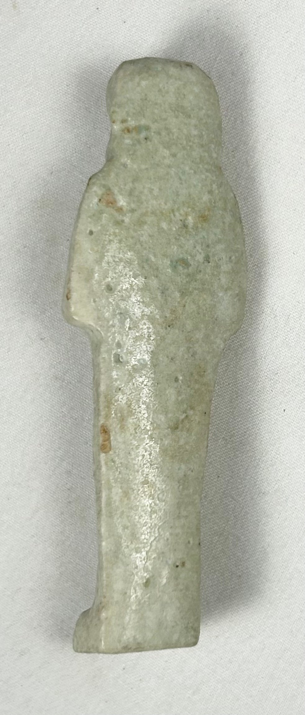 Egyptian faience ushabti with crossed arms and spiritual symbolism