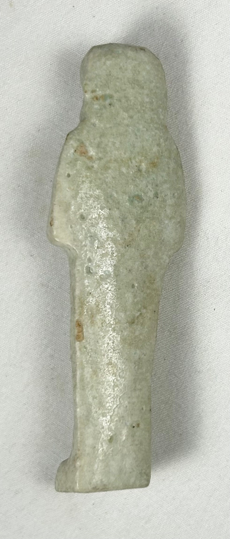 Egyptian faience ushabti with crossed arms and spiritual symbolism