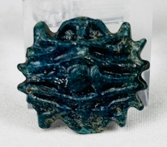 Late Period Egyptian faience starburst amulet with burial patina