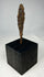Authentic ancient forged iron projectile point photographed on museum-style stand