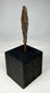 Side profile of ancient European iron weapon point displayed vertically