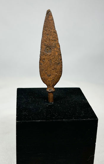 Historic European iron weapon point with tapered tang displayed upright