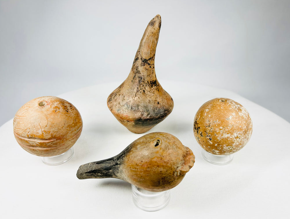 Ancient Pre-Columbian ceramic ritual rattles from Mesoamerica, hand-formed with internal sound pellets.