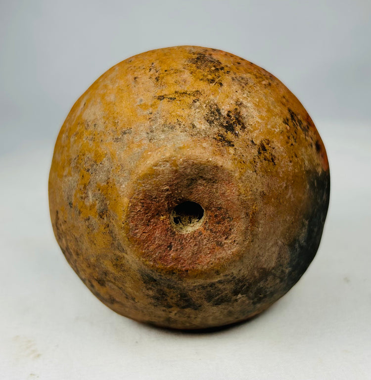 Ancient ceremonial rattles from the Pre-Columbian Americas, hand-formed clay with earthen tones.