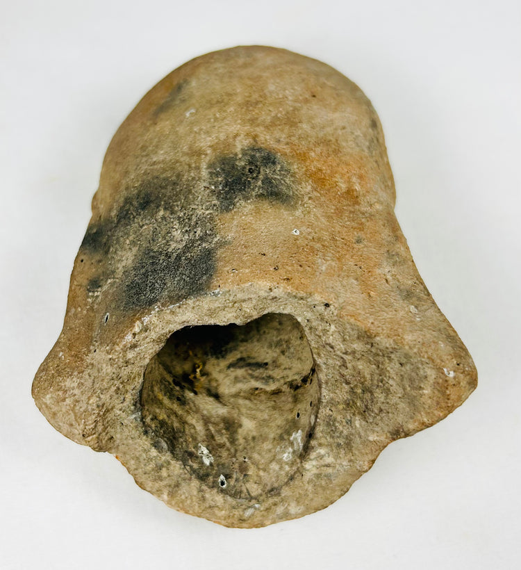 Ancient Mesoamerican terracotta head fragment with strong facial modeling and archaeological surface wear.